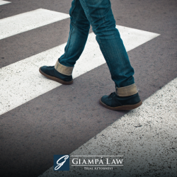 A pedestrian in Yonkers using the crosswalk to cross the street