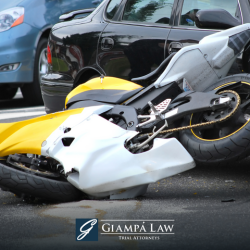 A damaged motorcycle lying on the road after a Bronx motorcycle accident