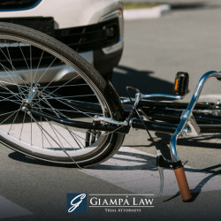 A bicycle lying on the street in front of a car in a New Rochelle crosswalk