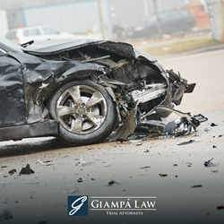 After a crash in The Bronx, a severely damaged car with its front end smashed in