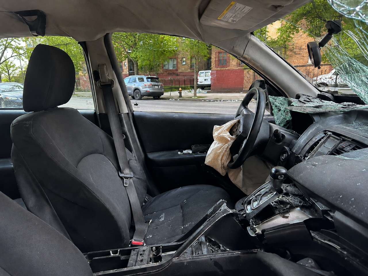 Damaged vehicle after a New York car accident with a seat belt visible inside